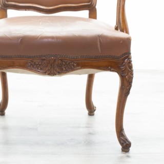 Sillón clásico de madera tapizado en piel marrón